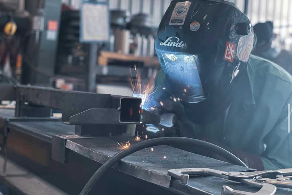 a welder fabricating a trailer with Flexiride torsion axles